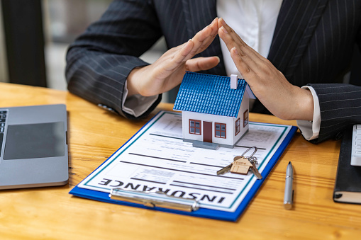 Real estate agent offer house design and contract. Approval of a contract to buy or sell a home. Offers mortgage loans and home insurance concept.