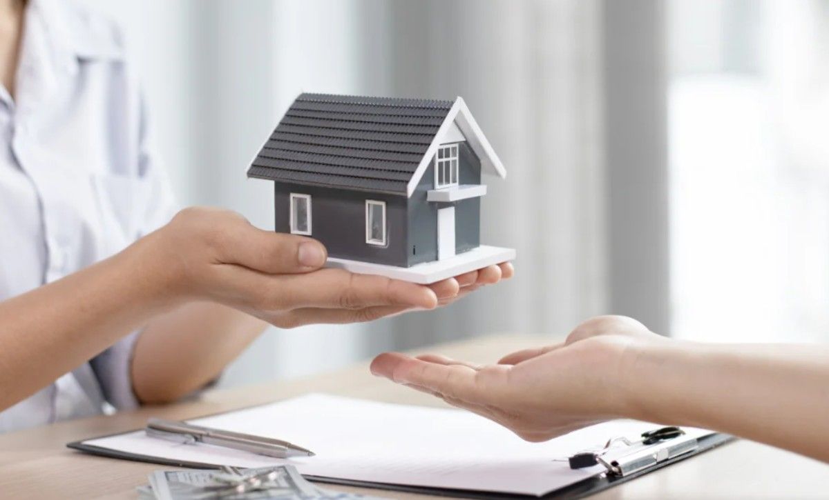 a person holding house model