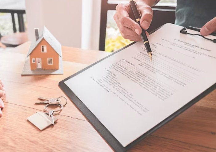 a man holding a contract and pen